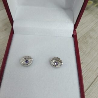 Aros plata rodinada ojo circon morado