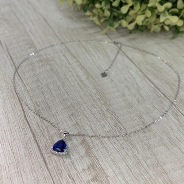 Collar plata rodinada punto de luz azul triangular