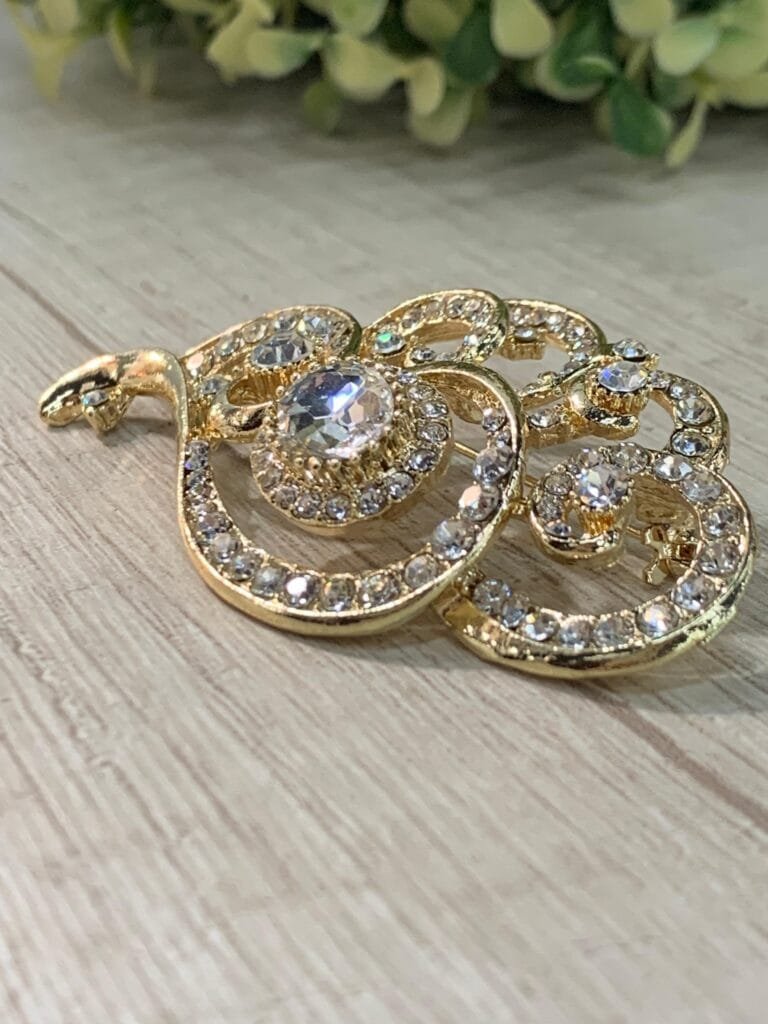Prendedor dorado circones ondas fantasia fina