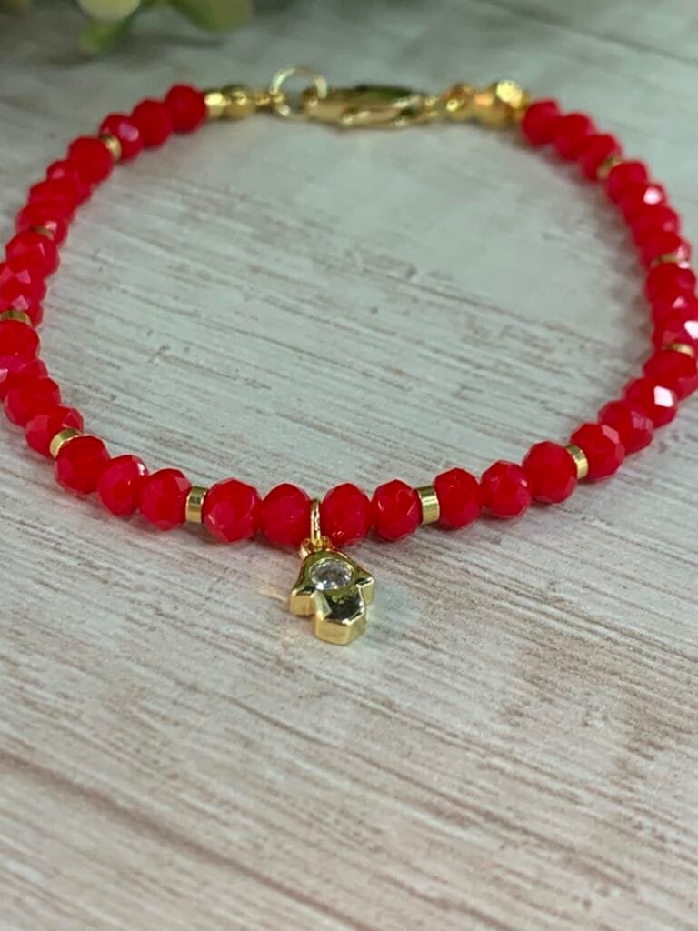 Pulsera baño en oro cristales rojos dije mano de fatima