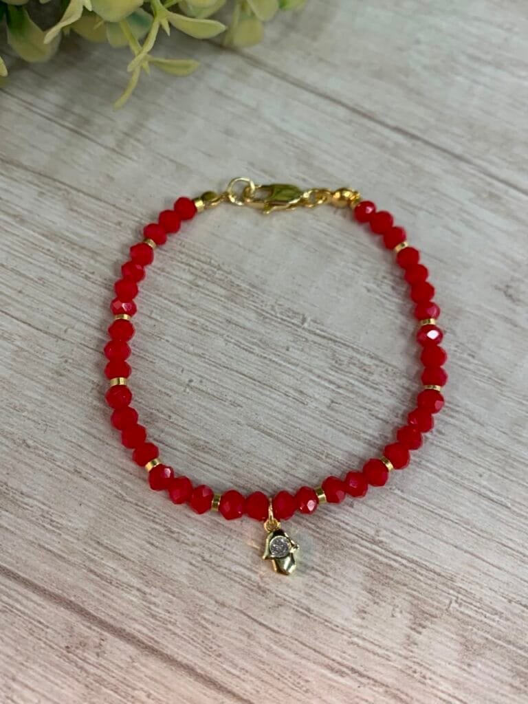 Pulsera baño en oro cristales rojos dije mano de fatima