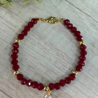 Pulsera baño en oro cristales burdeo con circon