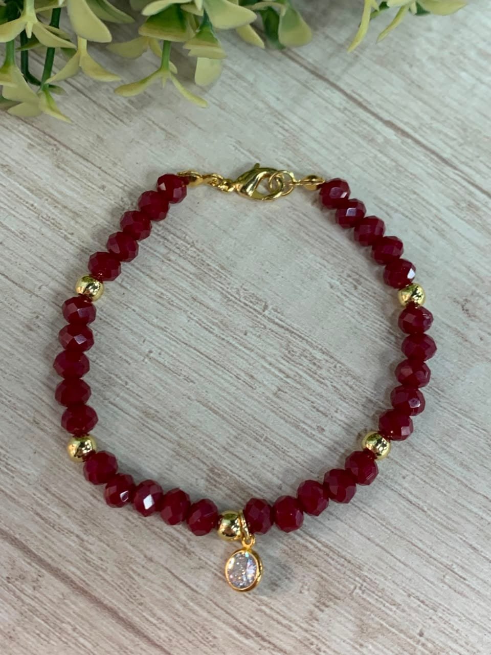 Pulsera baño en oro cristales burdeo con circon
